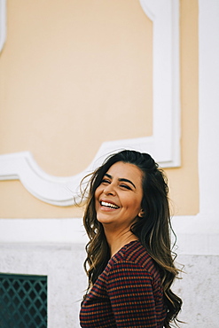 Smiling woman by wall, Lisboa, Lisbon, Portugal