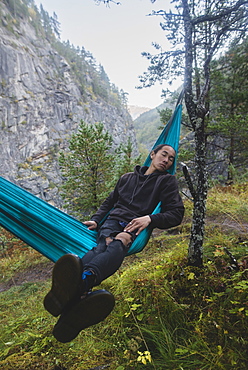 Young man resting in hammock