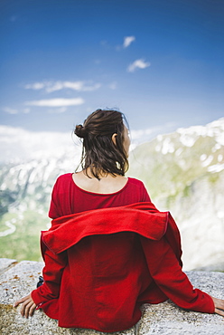 Switzerland, Appenzell, Woman in red jacket looking at mountain landscape