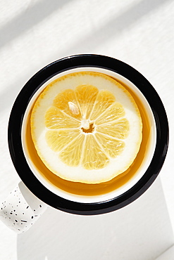 Lemon slice in cup of tea