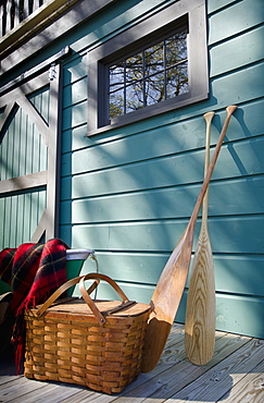 Oars and picnic supplies by blue wall