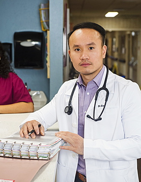 Doctor next to paperwork on bench