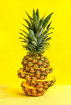 Sliced pineapple against yellow background
