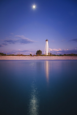 USA, Florida, Boca GrandeLighthouse reflecting in sea at night