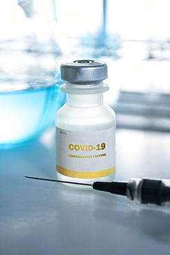 Vial of covid-19 vaccine and hypodermic needle