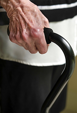 Close up of hand of senior woman holding cane