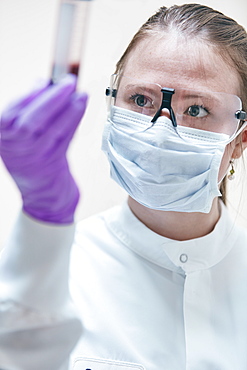 Female technician holding vial