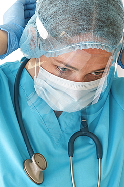 Nurse putting on face shield