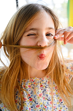 Portrait of girl (6-7) making funny faces