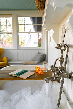 Bubble bath with book and candles