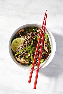 Asian meal in bowl with chopsticks