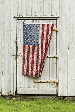 American flag hanging on barn door