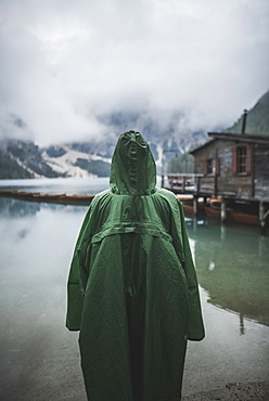 Italy, Man in raincoat standing Pragser Wildsee