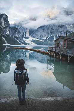 Italy, Woman standing by Pragser Wildsee in Dolomites