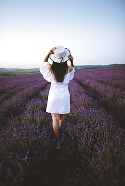 France, Woman in white dress in lavender field