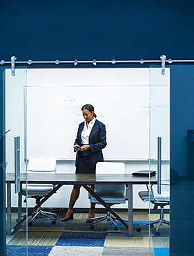 Businesswoman text messaging in office