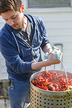 Caucasian man cooking crawfish outdoors