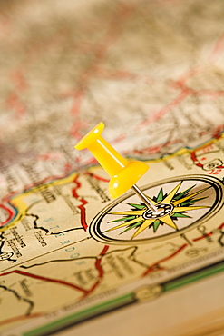 Closeup of push pin and map