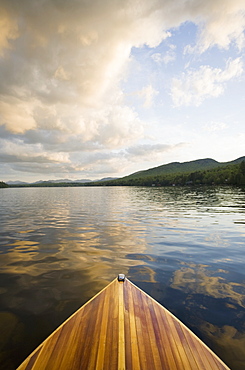 United States, New York, Lake Placid, Wooden boat on Lake Placid at sunset