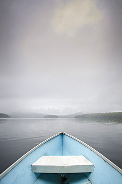 United States, New York, Lake Placid, View from rowboat on foggy lake