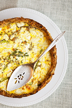 Still life of quiche made with eggs, asparagus, paprika and thyme