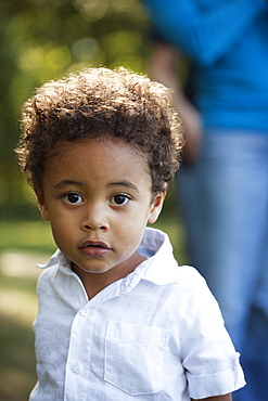 Portrait of preschool boy wearing white shirt looking at camera