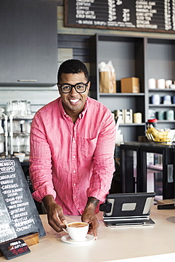 Coffee shop barista serving coffee