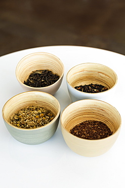 Selection of loose leaf teas in bowls, close-up