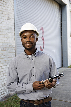 Portrait of young male architect outside building