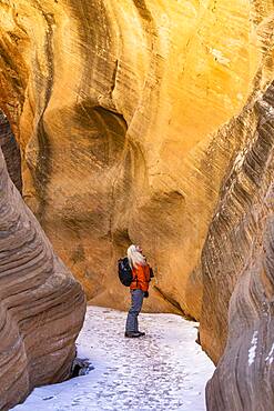 USA, Utah, Escalante, Woman hiking in slot canyon in Grand Staircase-Escalante National Monument