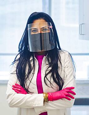 Portrait of female doctor wearing face mask and face shield