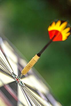 Dart arrow in target center of dartboard