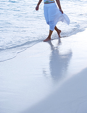 Woman strolling the beach