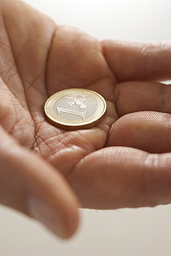 Closeup of Euro coin in palm