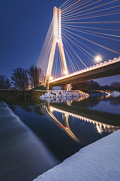 Poland, Subcarpathia, Rzeszow, Suspension bridge at night in winter