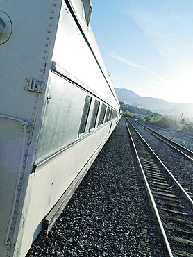 Close-up of passenger train crossing landscape