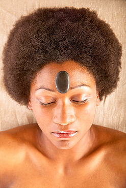 Woman with rock on forehead