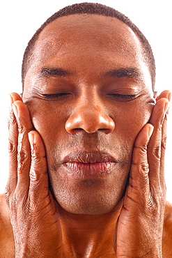 Close-up of man rubbing face