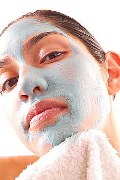 Close-up of woman removing blue facial mask