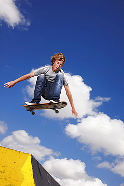 Young man on skateboard jumping