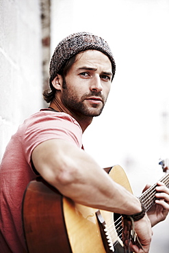 Portrait of musician playing guitar outdoors