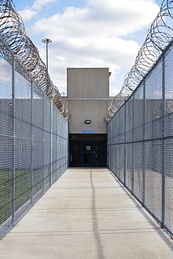 USA, Virginia, Pavement and chainlink fence in prison