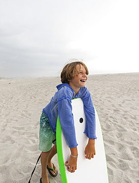 Boy (8-9) with body board on Grotto Beach