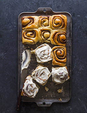 Overhead view of freshly baked cinnamon buns on baking sheet