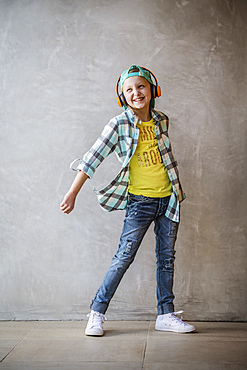 Portrait of smiling girl (10-11) with headphones