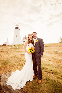 Portrait of married couple, lighthouse in background, USA, Maine, Bristol 