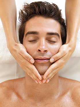 Man receiving massage in spa