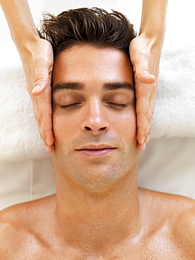 Man receiving massage in spa