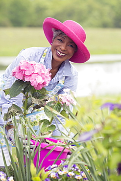 Portrait of senior woman working in garden, USA, New Jersey, Old Wick 