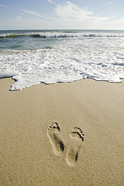 Footprints on sandy beach